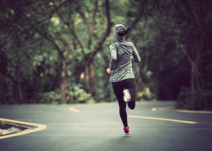 woman jogging along street