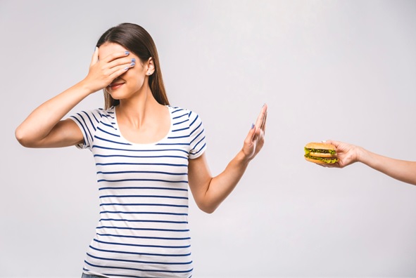 woman refusing a burger stock image