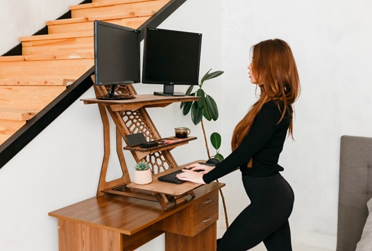 woman standing at computer stock image
