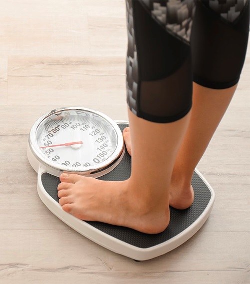 woman standing on scales stock image