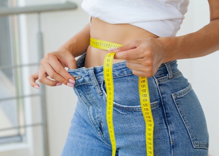 woman with tape measure around waist