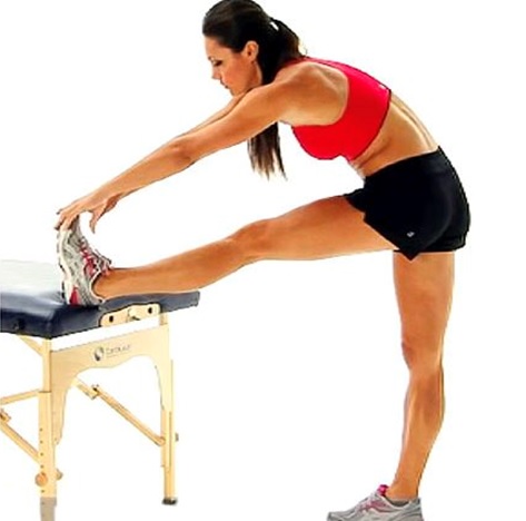 woman stretching touching toes on bench 